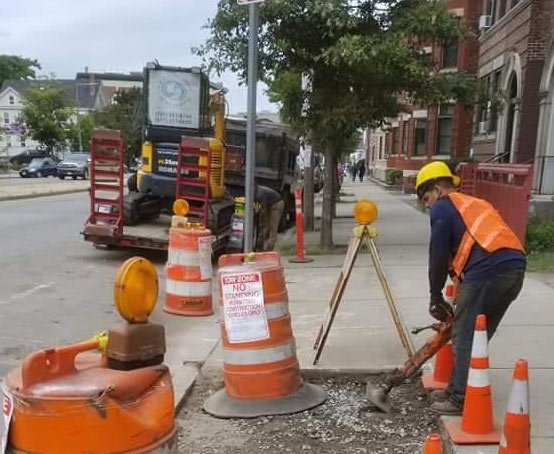 Hercules C&G Drain technician repairing a sewer line on a Boston street